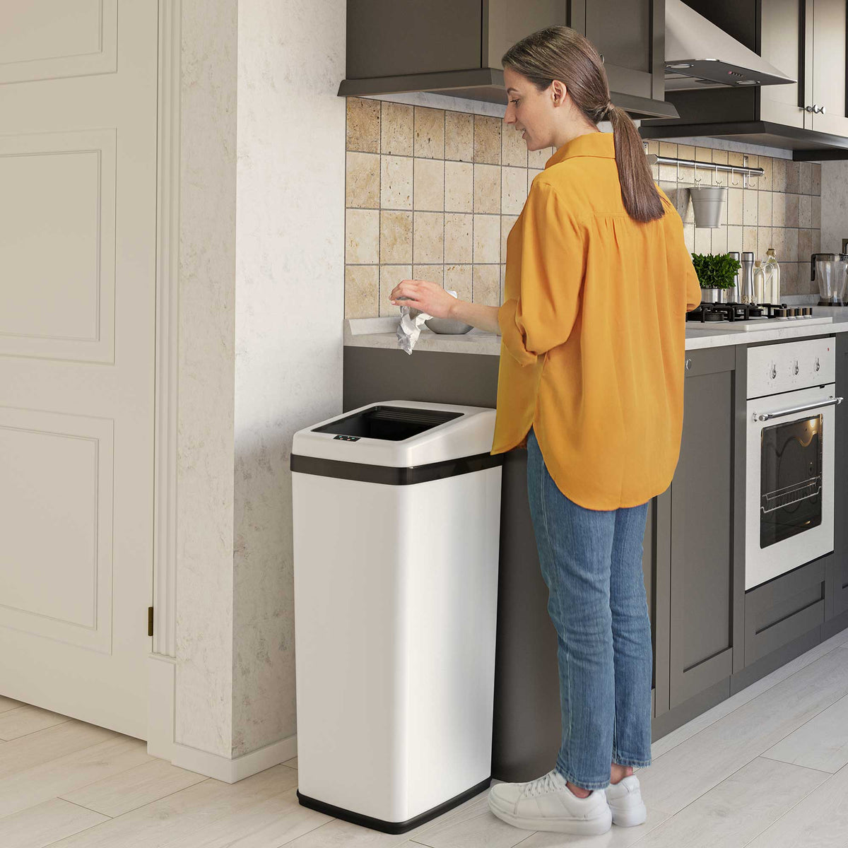 14 Gallon Sliding Lid Sensor Kitchen Trash Can and 2.5 Gallon Sensor Bathroom White Stainless Steel Combo Pack in use in kitchen