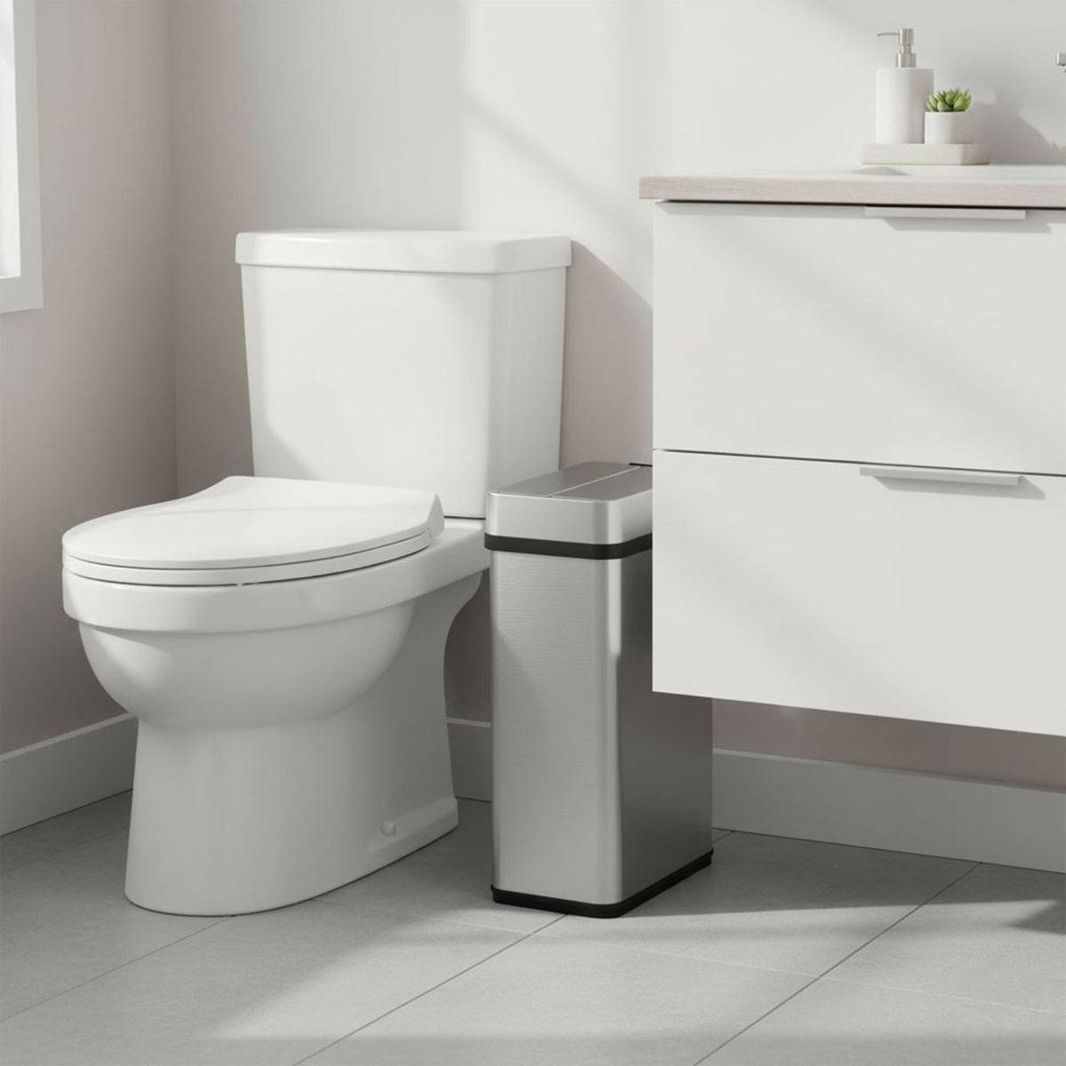 Slim iTouchless 4-gallon stainless steel sensor trash can fits neatly beside a toilet.